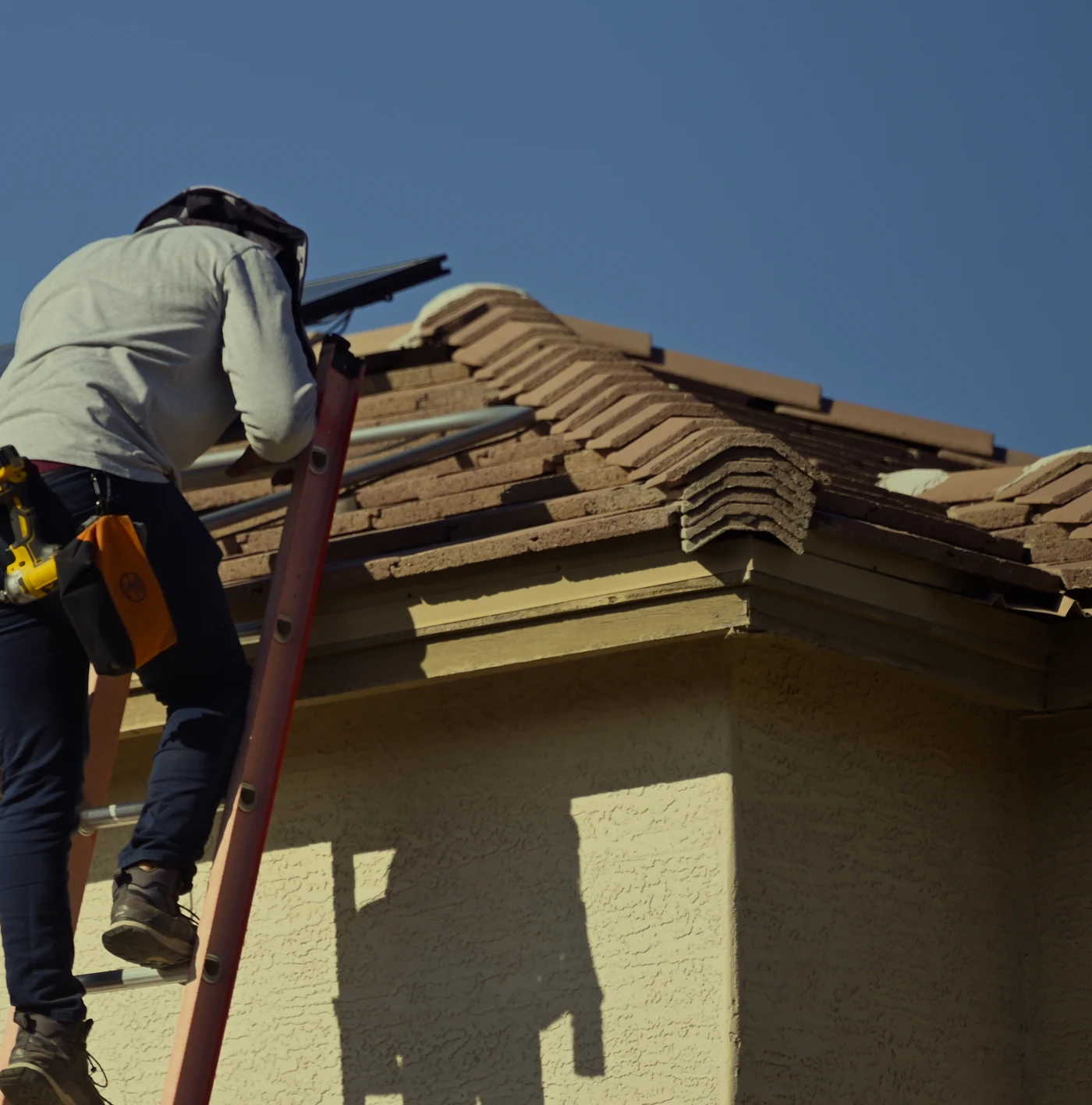 Arizona Network technician working beside a residential roof